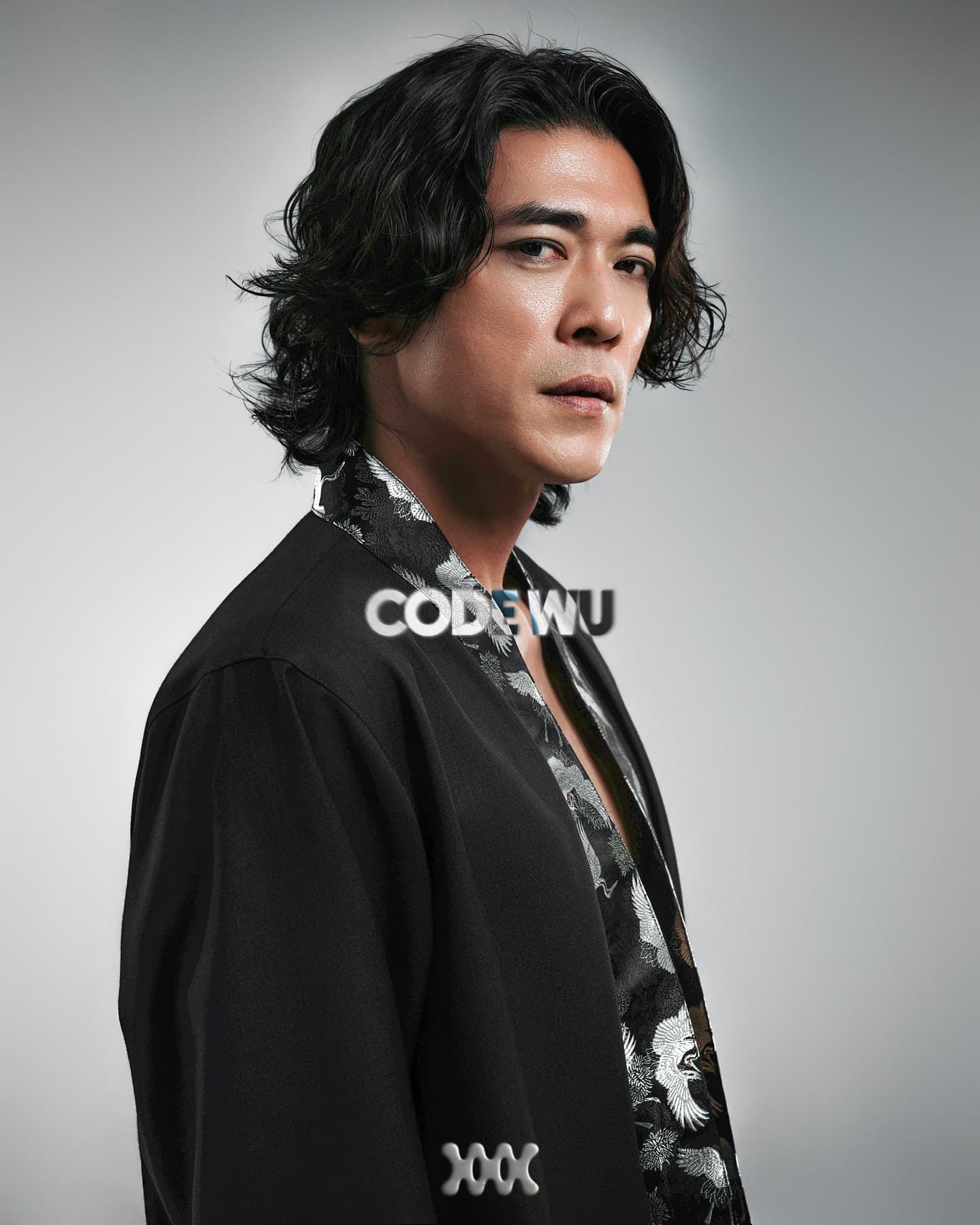 Studio portrait of Code Wu on grey, name over the chest